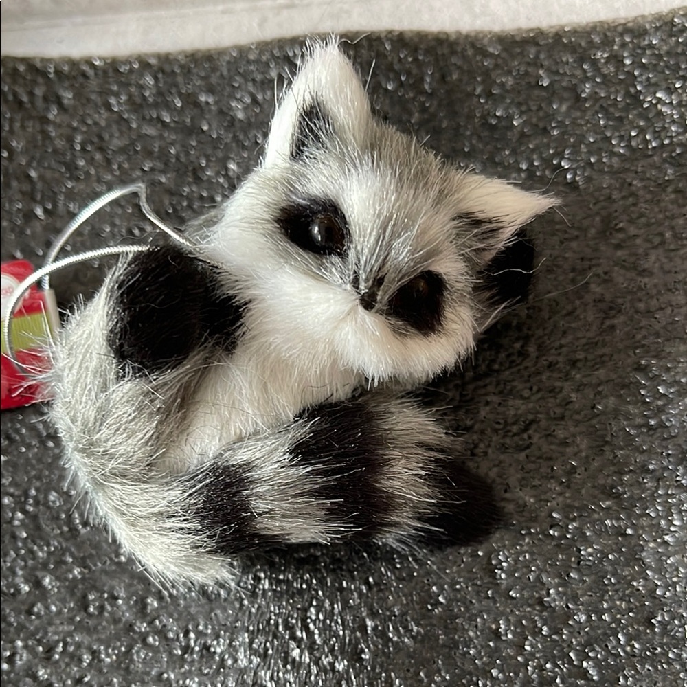 🐸 Furry gray raccoon HOLIDAY INSPIRATIONS ornament hangs from a silver cord - 3”